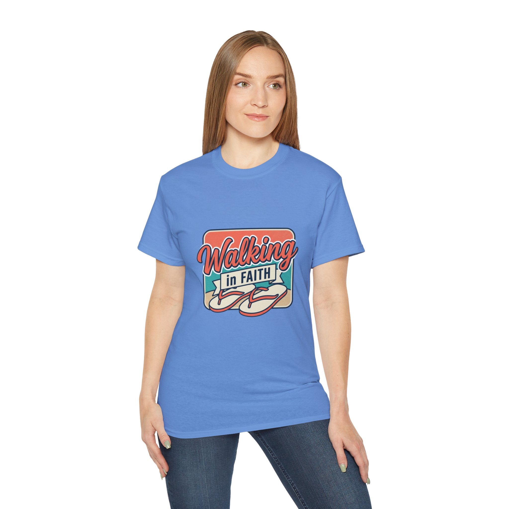 Walking in Faith Beach T-Shirt worn by a woman, showcasing its coastal charm and inspirational design.