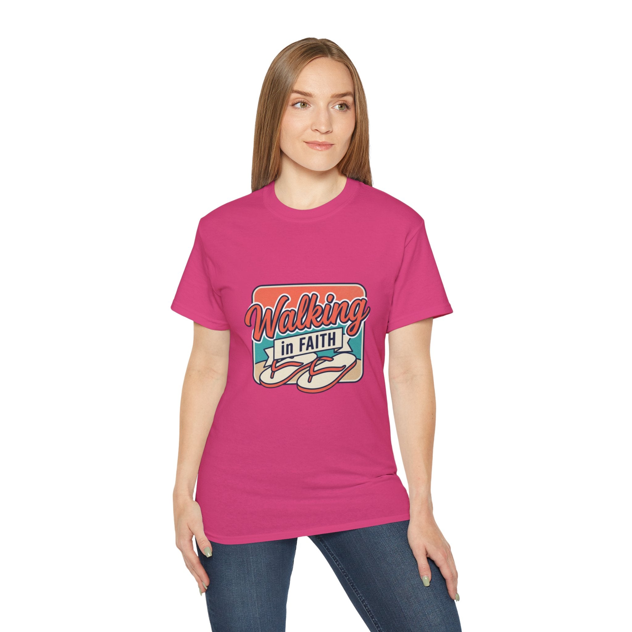 Walking in Faith Beach T-Shirt featuring a colorful design worn by a model in pink for coastal charm and faith.