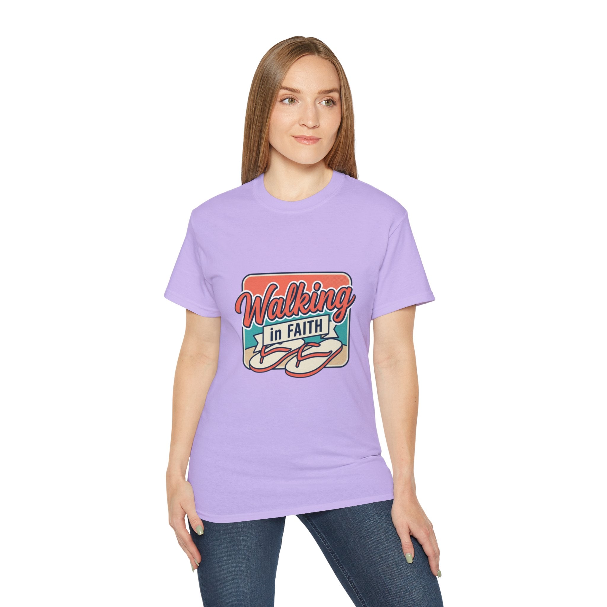 Walking in Faith Beach T-Shirt displayed on a model wearing a lavender tee with a coastal design and faith-inspired message.