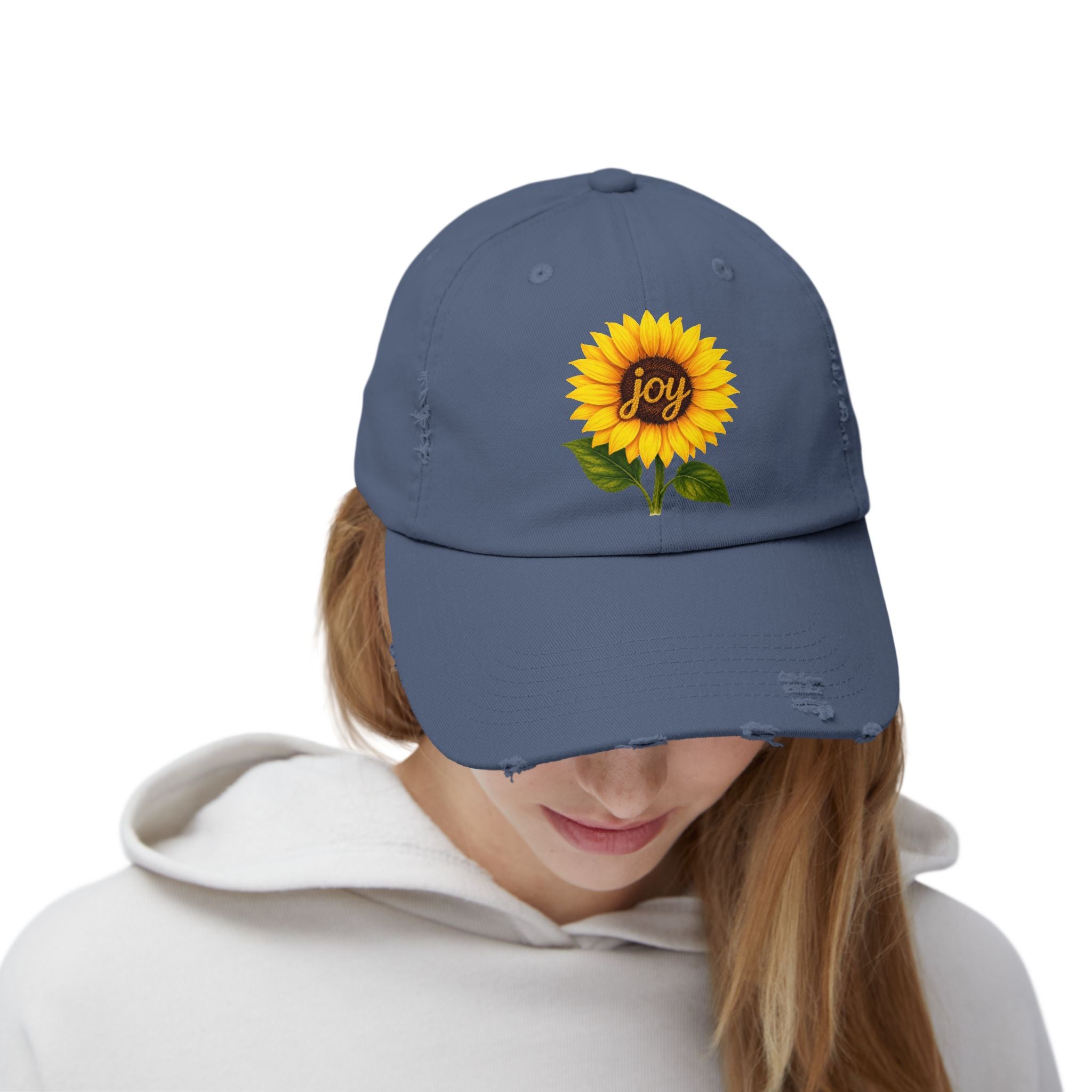 Sunflower Joy Distressed Cap featuring hand-painted sunflower design with the word joy, worn by a model.
