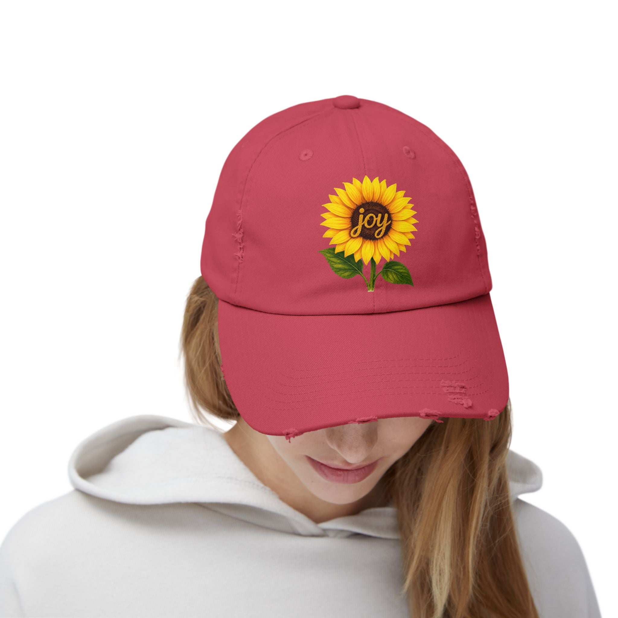 Sunflower Joy Distressed Cap worn by a person, featuring a hand-painted sunflower and the word 'joy'.