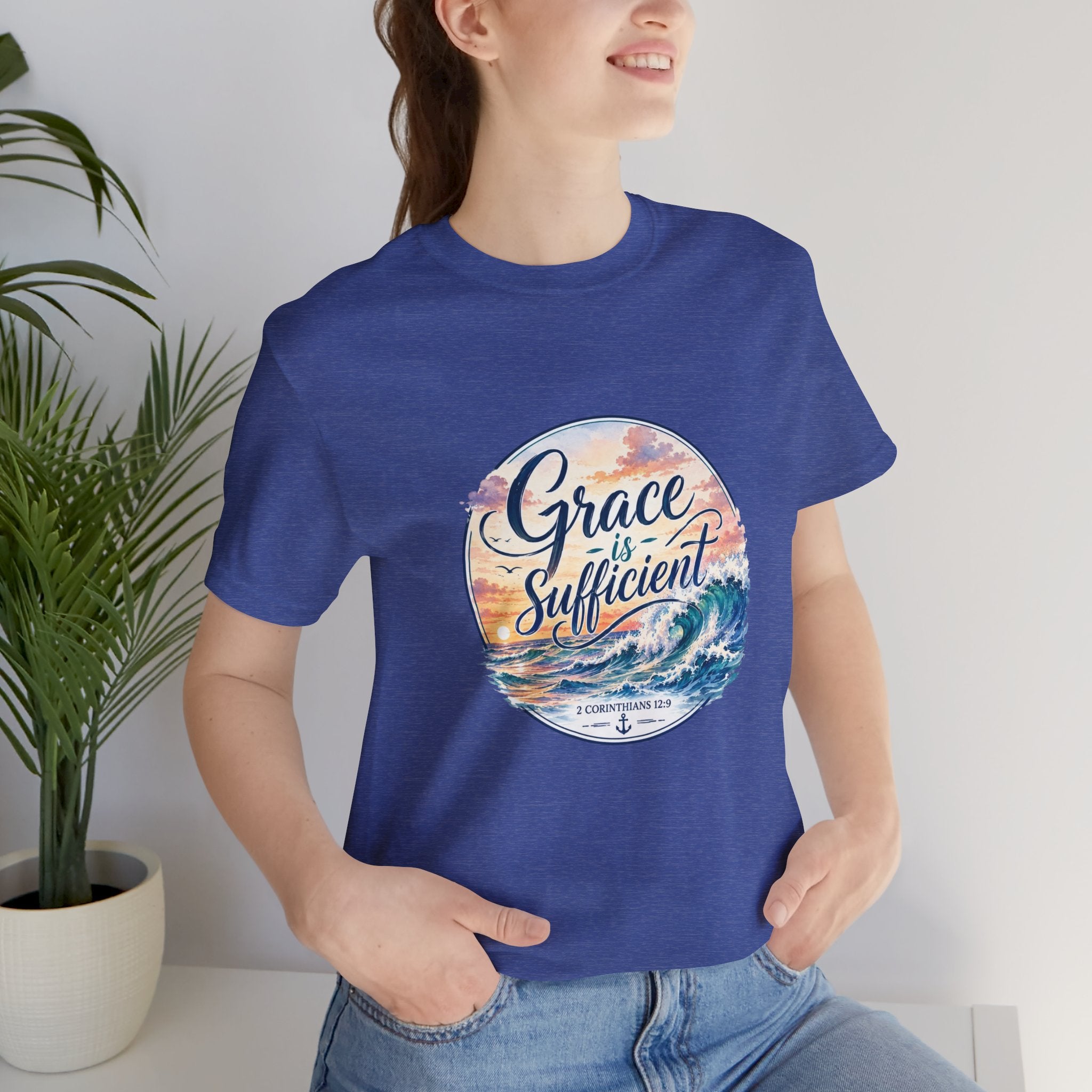 Grace Is Sufficient Tee worn by a smiling woman, featuring soothing beach graphic and inspirational text.