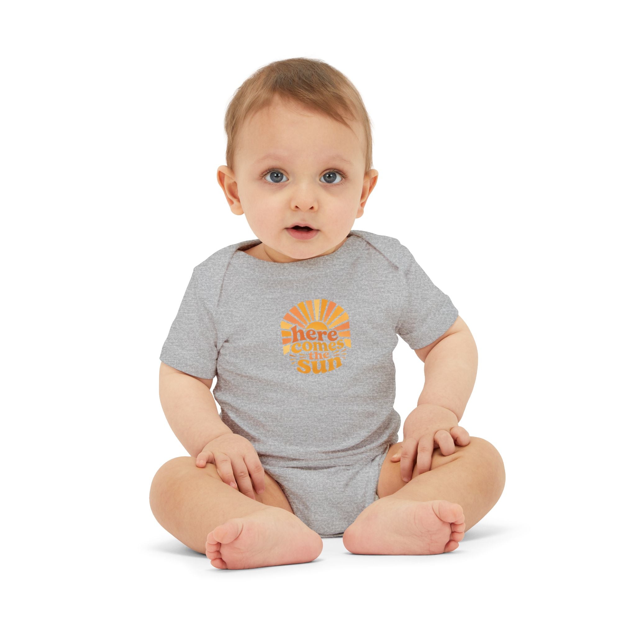 Cute Baby Bodysuit featuring the phrase 'Here Comes The Sun' on a gray infant one-piece.