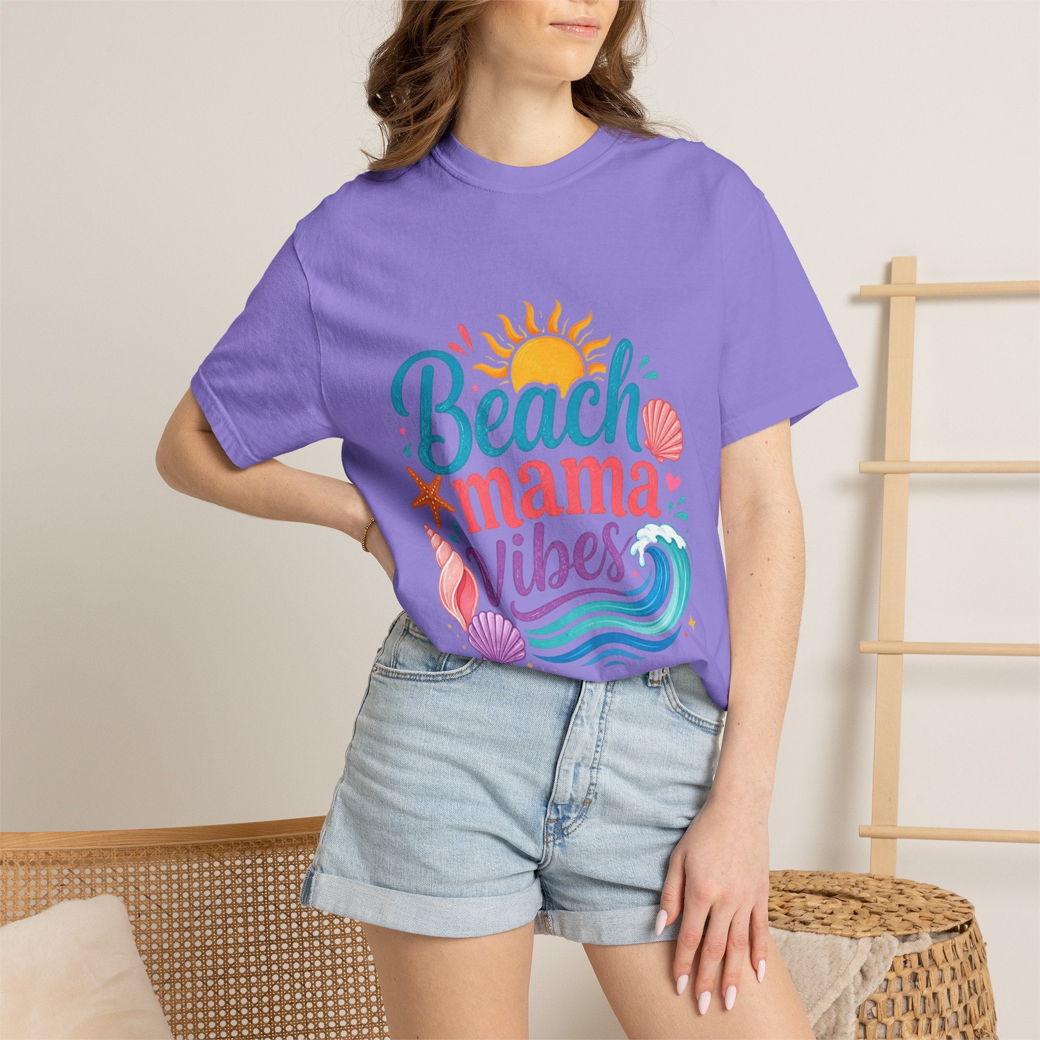 Beach Mama T-Shirt — Women's Coastal Mom Tee worn by a woman, featuring colorful beach-themed design on a purple shirt.