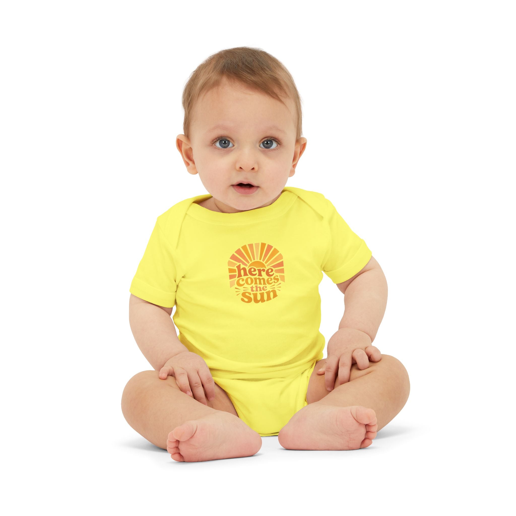 Cute Baby Bodysuit in bright yellow with the phrase 'Here Comes The Sun' worn by an adorable baby.
